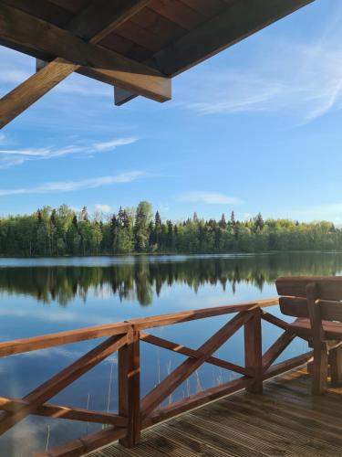 a view of a lake from the porch of a cabin at Villa Avoti in Sigulda