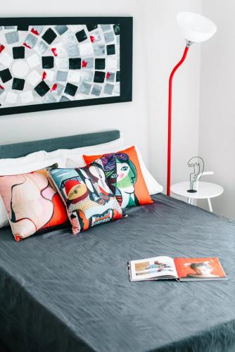 a bedroom with a bed with two pillows and a lamp at Sea Breeze Experience in Kavála