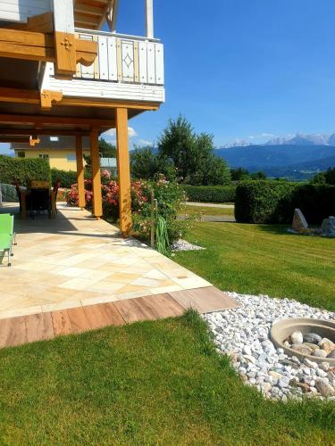 a backyard with a deck and a fire pit at Ferienwohnung Albert Egger in Nötsch