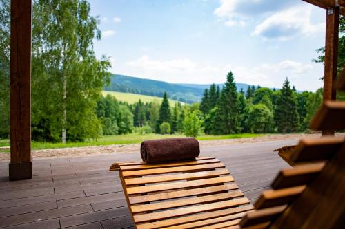 a bench with a purse sitting on top of it at Amenity Hotel & Resort Orlické hory in Deštné v Orlických horách