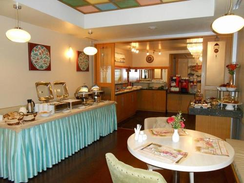 a restaurant with a counter with a table and chairs at Dareyn Hotel in Istanbul
