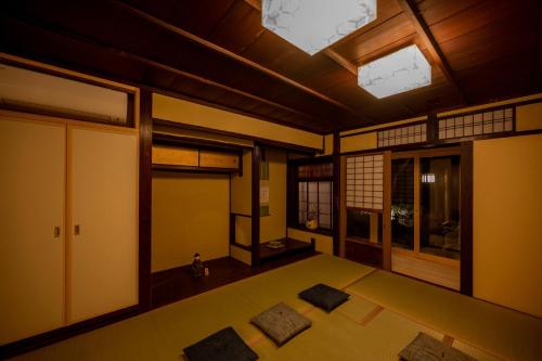 a room with mats on the floor and a ceiling at CAMPTON Higashiyama Roku in Kyoto