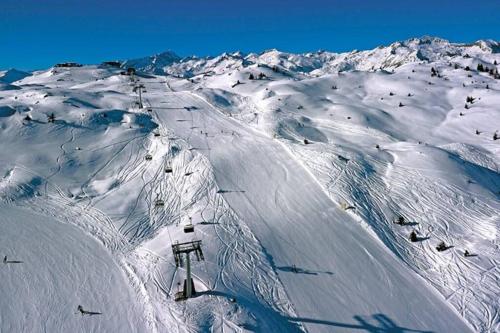 a snow covered ski slope with a ski lift at APPARTAMENTO A MADONNA DI CAMPIGLIO in Madonna di Campiglio