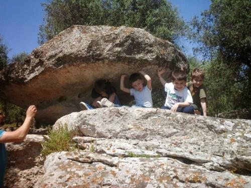a group of children sitting on top of a rock at B&B Terra Serena in Santa Cesarea Terme