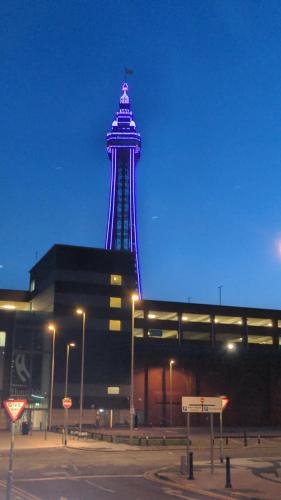 a eiffel tower is lit up in purple at The Winter Garden Suites in Blackpool