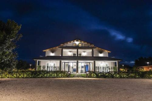 a large white house at night with lights at Podere Vasella - Suite junior sx in Capranica