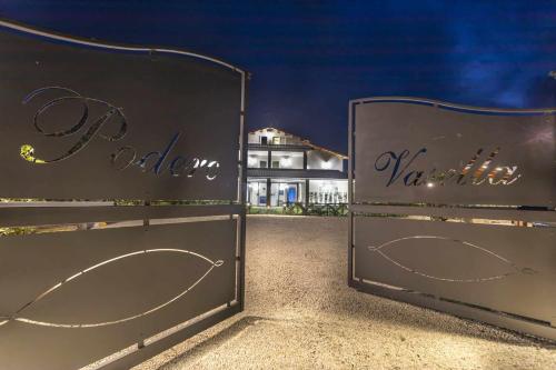 two metal gates with the wordsoria vientiane in front of a house at Podere Vasella Suite junior dx in Capranica