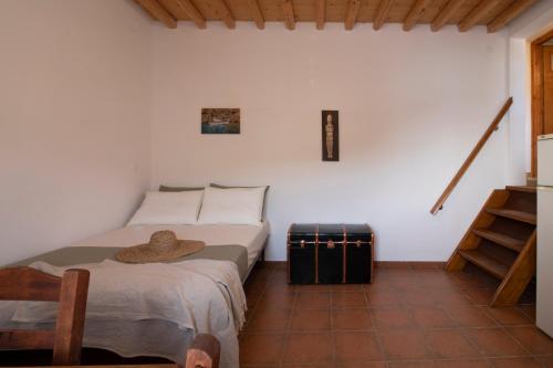 a bedroom with a bed with a hat on it at Cheronissos View in Sifnos