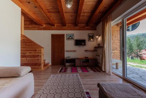 a living room with a couch and a tv at Etno selo Zminica in Žabljak