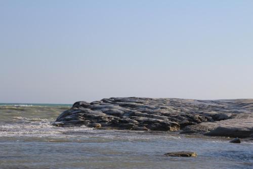 a group of rocks in the water on a beach at Le Zarafe in Caltabellotta