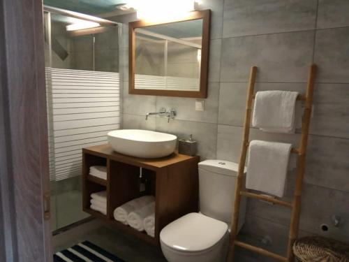 a bathroom with a sink and a toilet and a mirror at Loft by the sea-Agios Nikolaos-Lefkada in Ágios Nikólaos