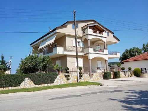 a large building with a fence in front of it at Loft by the sea-Agios Nikolaos-Lefkada in Ágios Nikólaos