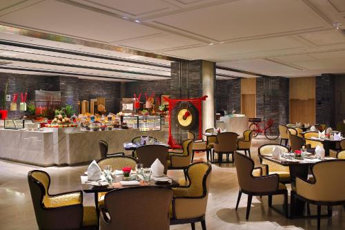 a restaurant with tables and chairs and a buffet at Crowne Plaza Beijing Lido by IHG in Beijing