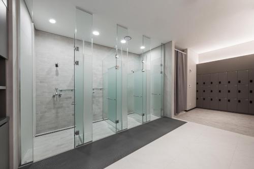 a bathroom with a shower with glass doors at Nine Tree Premier Hotel Seoul Pangyo in Seongnam