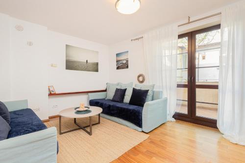 a living room with a couch and a table at Apartments Tarifa - by the sea by Renters in Sopot