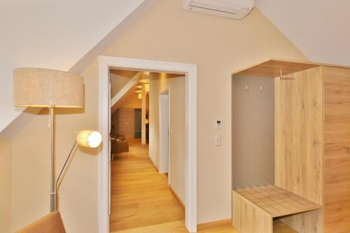 a hallway leading to a living room with a ceiling at Hotel Theophano in Quedlinburg