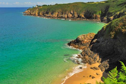 an aerial view of a beach next to the ocean at VTF L'Hotel Des Bains in Saint-Cast-le-Guildo