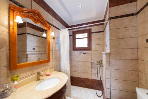 a bathroom with a sink and a shower at Luxury Rustic Villa Mountain View in Lefkada Town