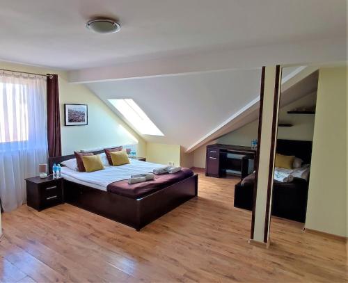 a large bedroom with a bed and a piano at Villa Magna in Gdynia