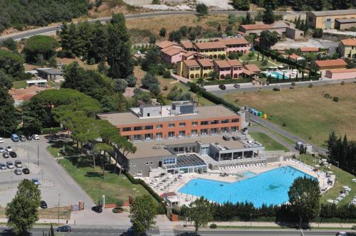 a large building with a lot of trees at Hotel Delle Terme Di Venturina in Venturina Terme