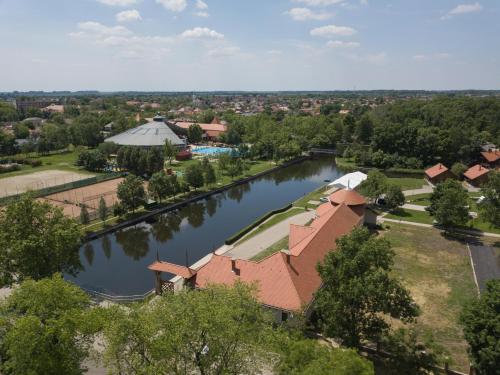 an aerial view of a house and a river at Hotel Kumánia in Kisújszállás