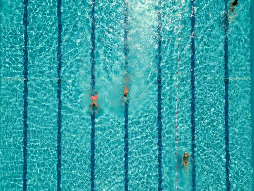 a group of people swimming in a swimming pool at Hotel Kumánia in Kisújszállás