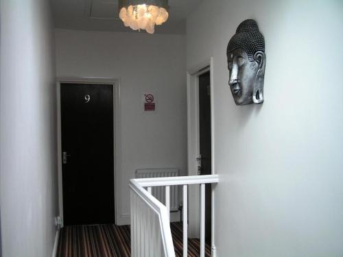 a mask hanging on a wall in a hallway at Devon Guest House in Blackpool
