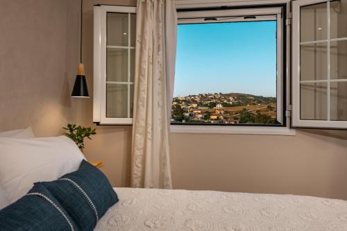 a bedroom with a bed and a window with a view at Vardakis house in Volímai