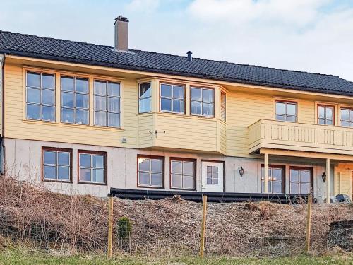 a large yellow house on top of a hill at 6 person holiday home in Tau in Tau