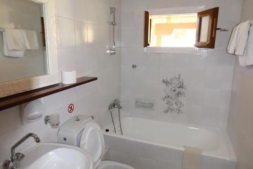 a bathroom with a sink and a toilet and a tub at Sonia's Apartment in Fiscardo Waterfront in Fiskardo