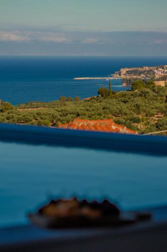 a view of the ocean from the top of a hill at Georgianna's suite with private pool , 'greysuite' in Kómpoi