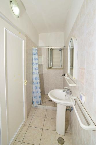 a white bathroom with a sink and a shower at SoleMarePonza Casa Maria in Ponza