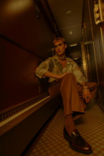 a woman is sitting on a train at Train Lodge Amsterdam in Amsterdam