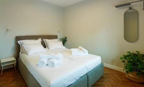 a bedroom with a bed with towels on it at alma in Yerushalayim