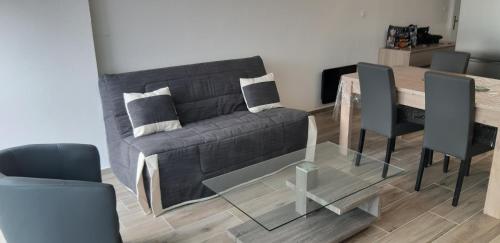 a living room with a couch and a table at appartement T3 Saint-Cyprien plage in Saint-Cyprien