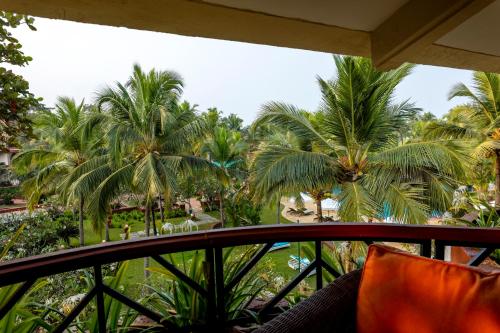 a view from the balcony of a resort with palm trees at Caravela Beach Resort in Varca