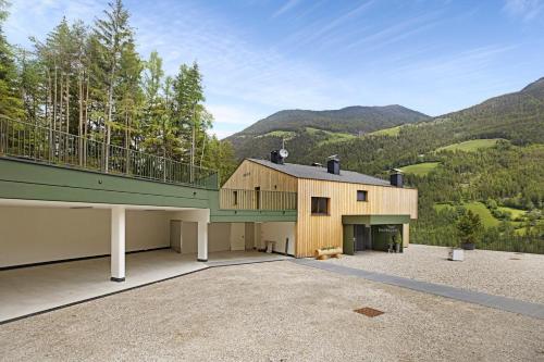 a large house with a balcony on top of it at Archehof Hochzirm Lodge Anna in Campo Tures