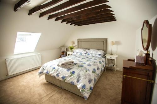 a bedroom with a bed with a blue and white comforter at Arthur Street cottage in Hillsborough