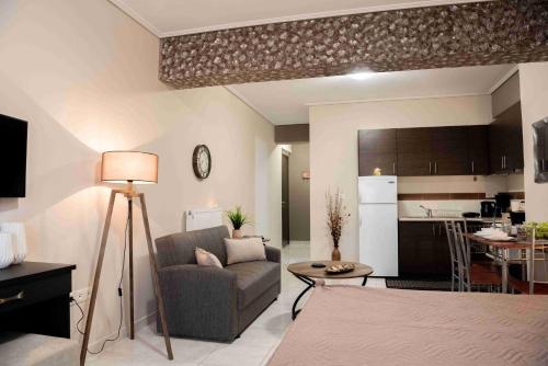 a living room with a couch and a kitchen at Sparta View Apartments Nefelis Boutique Γ2 in Sparti