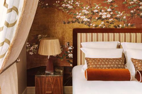 a bedroom with a bed with a floral wall at Saint James Paris in Paris