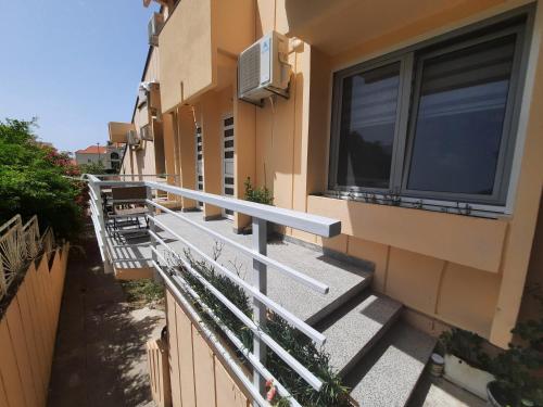 an empty balcony of a building with windows at Montenegro Sea Pearl Apartments Petrovac in Petrovac na Moru