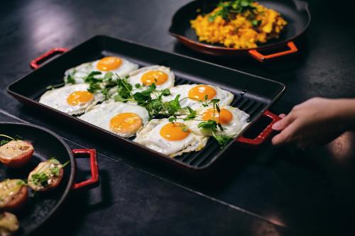 a tray of eggs on a table with other foods at Stord Hotel in Stord