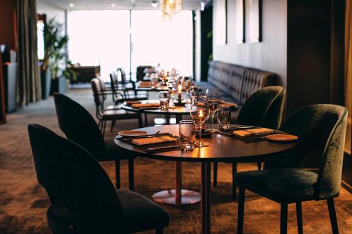 a row of tables and chairs in a restaurant at Stord Hotel in Stord