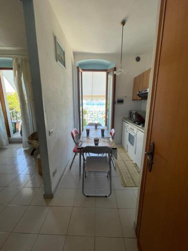 a table and chairs in a kitchen with a window at Appartamento con splendida vista - Lerici Centro in Lerici