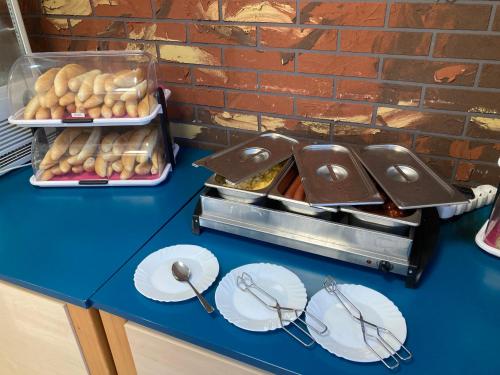 a blue counter with plates of food on a table at Penzion Grasel in Nové Syrovice