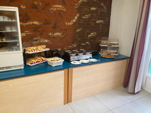 a blue counter with pastries on it next to a brick wall at Penzion Grasel in Nové Syrovice