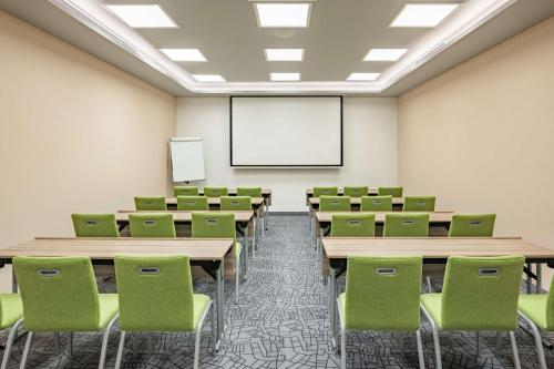 a classroom with desks and chairs and a whiteboard at Park Inn by Radisson, Riyadh in Riyadh