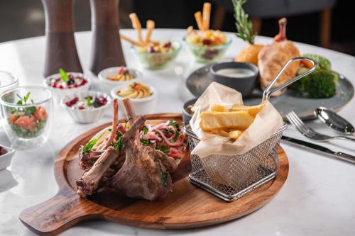 a plate of food on a table with food at Park Inn by Radisson, Riyadh in Riyadh