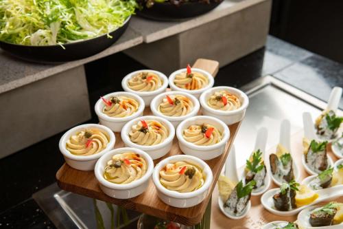 a bunch of appetizers in small dishes on a table at Park Inn by Radisson, Riyadh in Riyadh