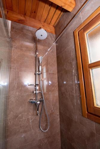 a shower with a shower head in a bathroom at Casa Mariví in Niembro